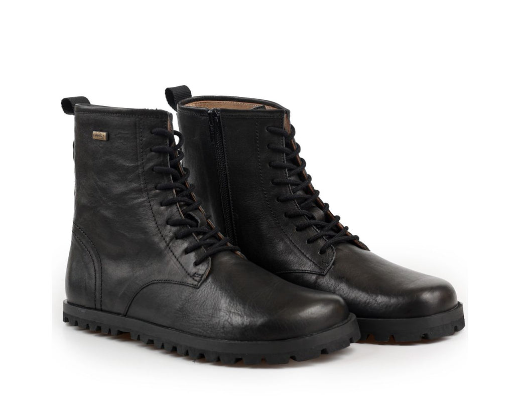 A pair of black leather tikki lands kombat lace-up ankle boots with a rugged lug sole, shown on a clean white background.
