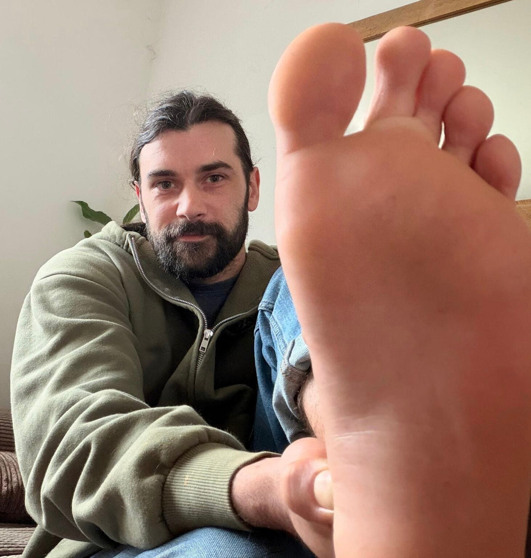 Daniel Adams, founder of Barefoot Brit Shop, holding a barefoot shoe