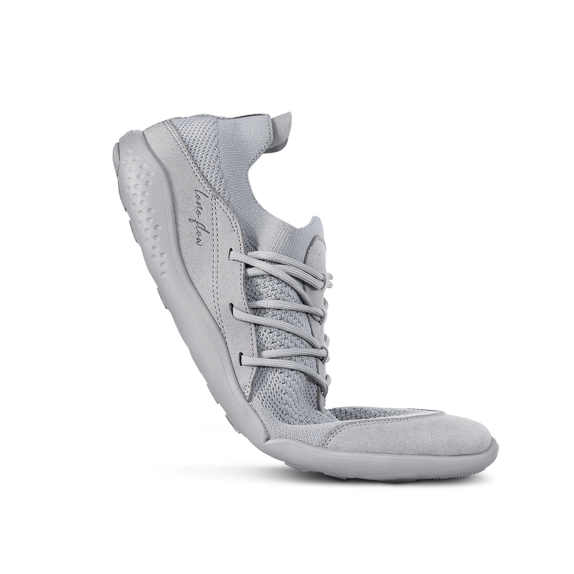 Grey LONO FLOW barefoot shoe bent to show sole flexibility