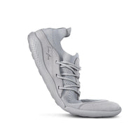 Grey LONO FLOW barefoot shoe bent to show sole flexibility