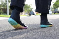 PaperKrane Kranebow barefoot boots on feet stepping on pavement showing rainbow sole