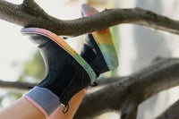 Child wearing PaperKrane Kranebow JNR kids barefoot Chelsea boots while climbing in a tree