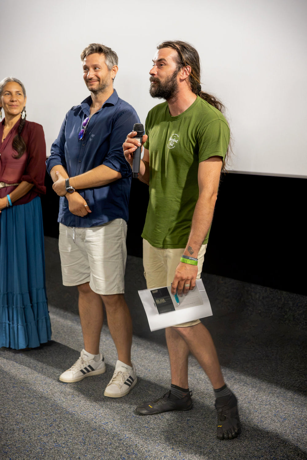 Daniel Adams speaking on stage at the documentary premiere of Stupid Shoes