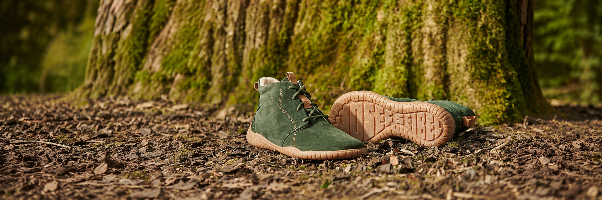 Josef Seibel Wynona 05 tanne barefoot ankle boots on autumn leaves beside mossy tree trunk