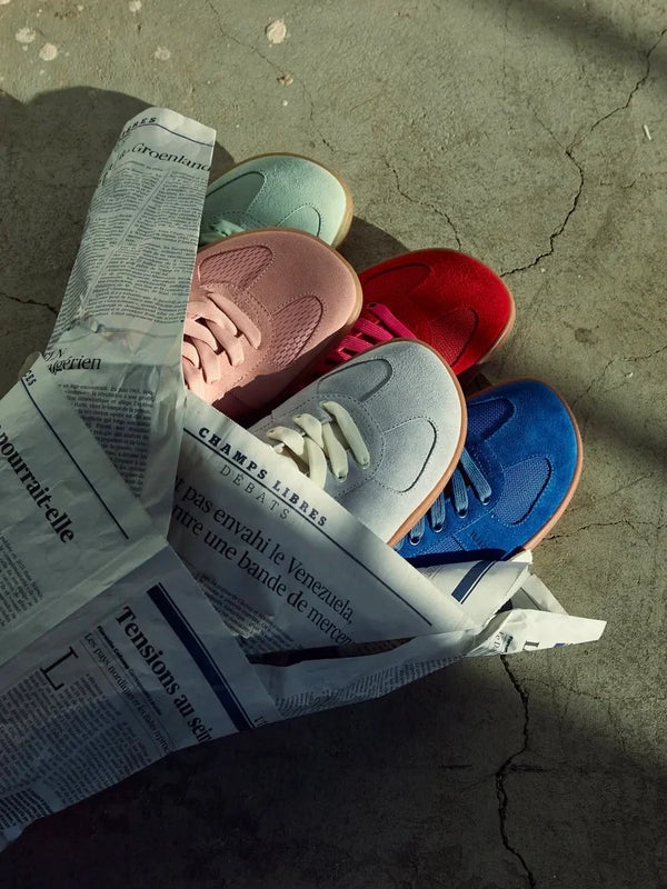 Colourful barefoot trainers arranged on newspaper wrapping
