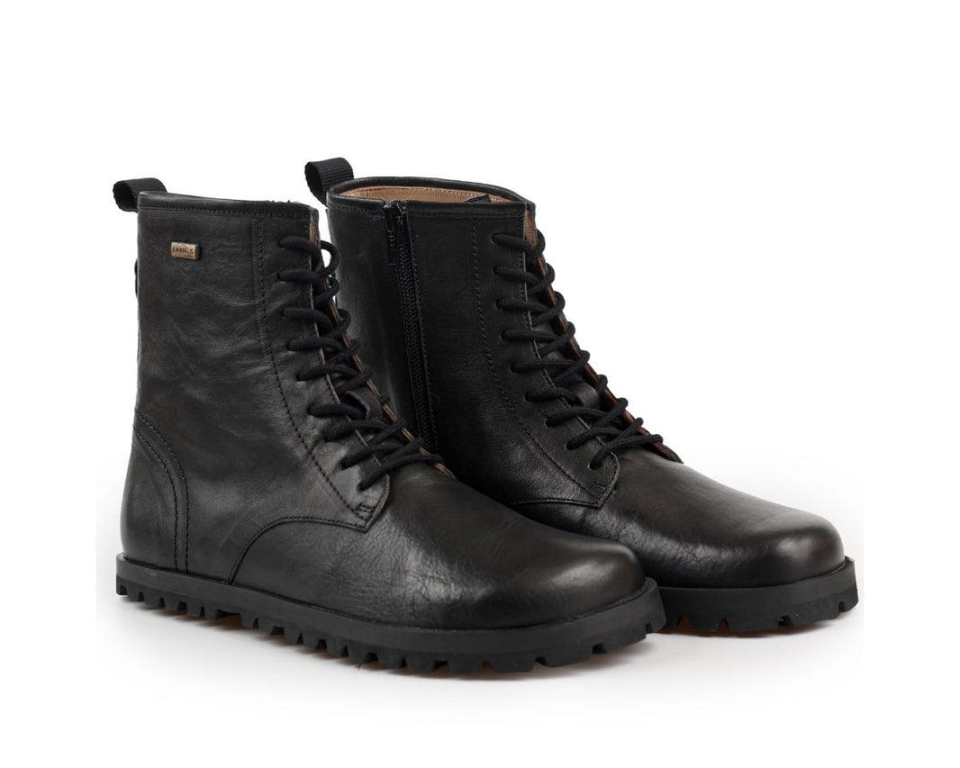 A pair of black leather tikki lands kombat lace-up ankle boots with a rugged lug sole, shown on a clean white background.